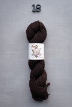 Load image into Gallery viewer, Brown skein of yarn with a label on a gray background