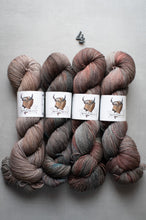 Load image into Gallery viewer, Three skeins of multicolored yarn with labels on a gray background