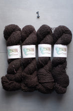 Load image into Gallery viewer, Four skeins of dark brown yarn with labels on a gray background