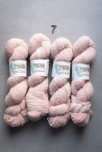 Load image into Gallery viewer, Four skeins of pink yarn with labels on a gray background