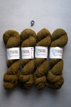 Load image into Gallery viewer, Four skeins of green yarn with labels on a gray background