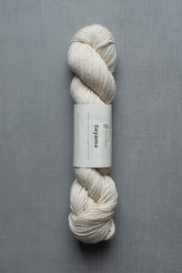 White skein of yarn with a label on a gray background
