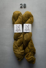 Load image into Gallery viewer, Two skeins of mustard yellow yarn with labels on a gray background