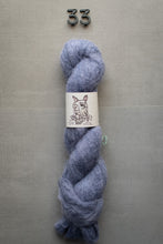 Load image into Gallery viewer, Blue skein of yarn with a label on a gray background