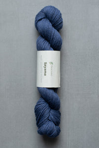 Blue skein of yarn with a label on a gray background