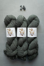 Load image into Gallery viewer, Three skeins of gray yarn braided together with Saka Pi labels on a gray background.