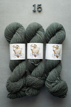 Load image into Gallery viewer, Three skeins of green yarn with labels on a gray background
