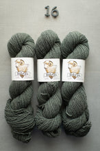 Load image into Gallery viewer, Three skeins of green yarn with labels on a gray background