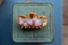 Load image into Gallery viewer, Decorative hair clip with strawberry design on a green metal surface