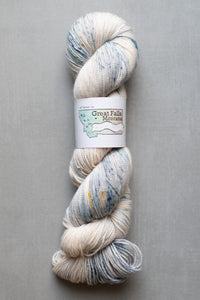 Yarn skein with a label on a gray background
