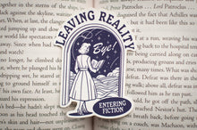 Load image into Gallery viewer, Sticker with text 'Leaving Reality Bye! Entering Fiction' on a book page