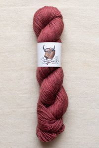 Red skein of yarn with a label on a beige background