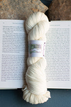 Load image into Gallery viewer, white skein of yarn on an open book