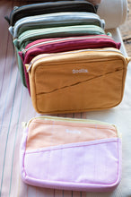 Load image into Gallery viewer, Stack of small pouches with 'Soolala' branding on a textured surface