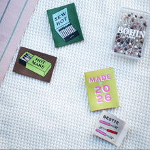 Load image into Gallery viewer, Collection of small cards and a box of pins on a textured surface