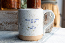 Load image into Gallery viewer, A speckled ceramic mug with a natural clay base, featuring the text 'YOU'RE MY FAVORITE WEIRDO. XO, YOUR BFF' in blue.