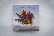 Floral design on a card with 'The Farmer's Daughter Fibers' and 'Indigenous Collective' text.