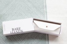 Load image into Gallery viewer, Open box with 'Bare Hands' branding on a textured surface