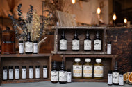 Collection of bottles on wooden shelves with a rustic background