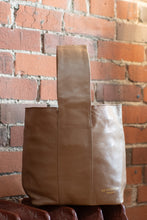 Load image into Gallery viewer, Brown leather tote bag with 'Bodrum Leather' branding against a brick wall.