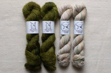Load image into Gallery viewer, Four skeins of yarn in green and beige on a light gray background with labels.