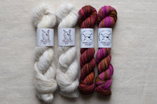 Load image into Gallery viewer, Two skeins of white yarn and two skeins of multicolored yarn on a neutral background with Spindles Yarns labels.