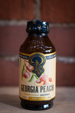 Load image into Gallery viewer, Georgia Peach beverage concentrate bottle with blue cap on a wooden surface