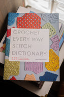 Book titled 'Crochet Every Way Stitch Dictionary' with colorful crochet patterns on the cover.