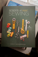 Book titled 'School of Sewing' by Shea Henderson with sewing tools on the cover.