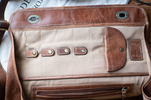 Load image into Gallery viewer, Close-up of a brown leather bag with visible stitching and hardware.