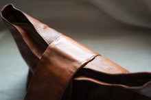 Load image into Gallery viewer, Close-up of a brown leather bag with a blurred background