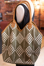 Load image into Gallery viewer, Mannequin wearing a patterned bag with brown handles in a blurred indoor setting
