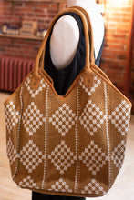 Load image into Gallery viewer, Brown woven bag with diamond pattern on a mannequin against a brick wall background