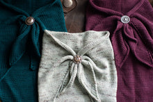 Load image into Gallery viewer, Three fabric wraps with decorative buttons on a textured surface