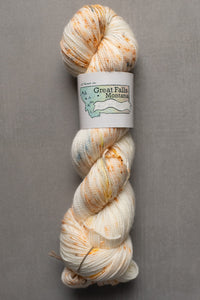 Yarn skein with a label on a gray background