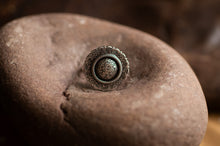 Load image into Gallery viewer, Silver ring with intricate design on a textured stone surface
