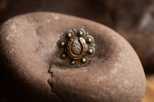 Load image into Gallery viewer, Silver ring with a horseshoe design on a stone surface