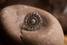 Load image into Gallery viewer, Bronze ring with floral design on a textured stone surface