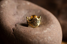 Load image into Gallery viewer, Gold ring with intricate design on a stone surface