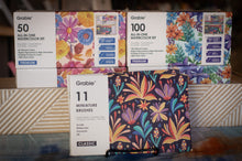 Load image into Gallery viewer, Grabie watercolor sets with floral designs on boxes