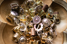 Load image into Gallery viewer, Collection of various metal buttons in different shapes and sizes on a metallic surface.