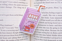 Load image into Gallery viewer, Book-shaped &#39;Book Worm Juice&#39; drink container on an open book