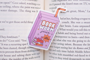 Book-shaped 'Book Worm Juice' drink container on an open book