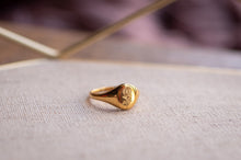Load image into Gallery viewer, Gold ring with engraved design on a textured surface