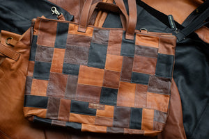 Patchwork leather bag with brown and black squares on a dark surface