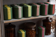 Shelves with green and brown jars and containers.