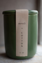 Load image into Gallery viewer, Green candle jar with a label reading &#39;neroli + cotton&#39; on a neutral background