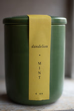 Load image into Gallery viewer, Green candle jar with a yellow label reading &#39;dandelion + mint&#39; on a neutral background