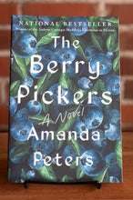 Load image into Gallery viewer, Book cover of &#39;The Berry Pickers&#39; by Amanda Peters with blueberry design on a stand.
