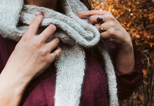 Load image into Gallery viewer, Person wearing a knitted scarf with a blurred autumn background
